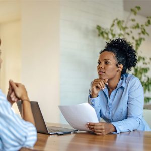 Woman conversing with someone across the table